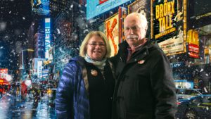 woman and man with NYC in the background